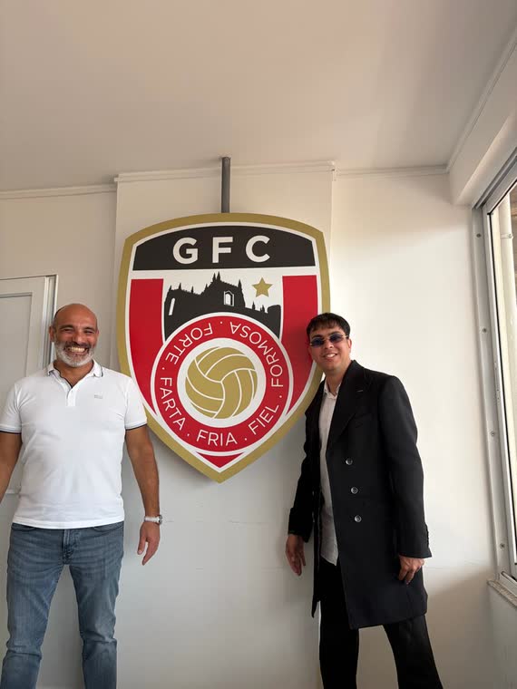 Jai Agarwal with the president of Guarda FC beside the club crest