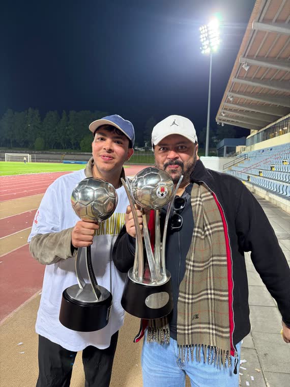 Jai Agarwal and a club director each holding a trophy