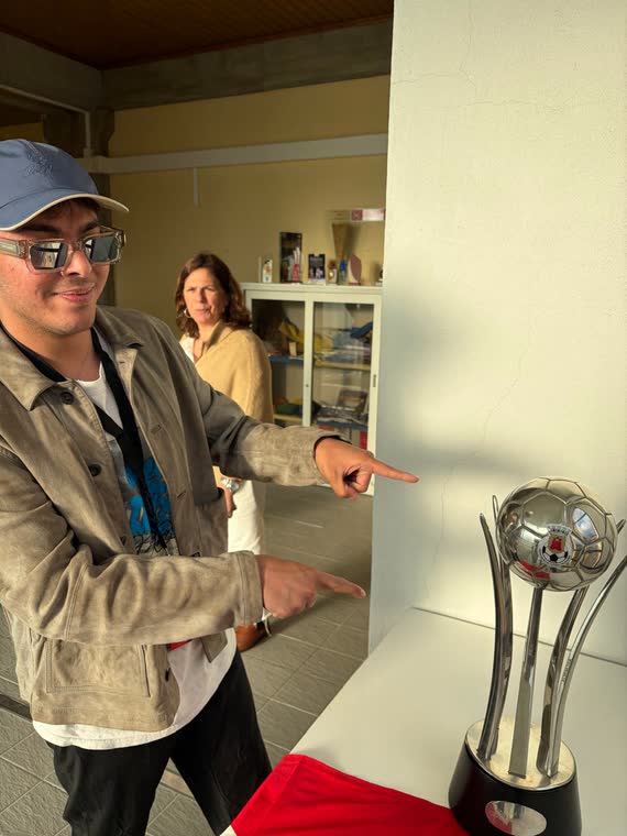 Jai Agarwal pointing at the Supertaça trophy at the club offices